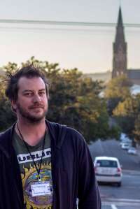 Director Rob Murray waits outside the NG Kerk Hall before the dress rehearsal of his new mask work Waterline, in Grahamstown on 1 July 2015, at the National Arts Festival. Rob Murray - known for Crazy in Love, Benchmarks and Pictures of You – presents a satirical look at Grahamstown’s water crisis. (Photo: CuePix/Mia van der Merwe)